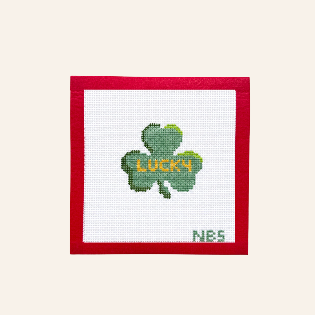 close up of canvas with a clover and work lucky